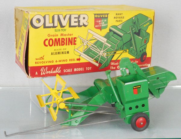 SLIK TOY 9830 OLIVER COMBINE: pressed steel & die cast, 14 in long, working, orig box worn, C8.
