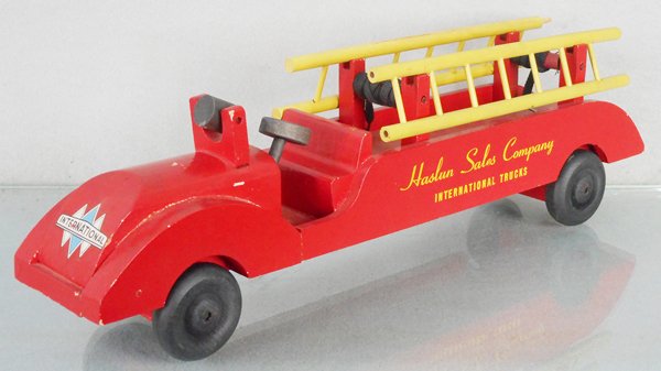 INTERNATIONAL FIRE DEMON LADDER TRUCK: by Commodities Corp, wooden, 16 in long, w/Haslan Sales Company International Truck decals, C8.