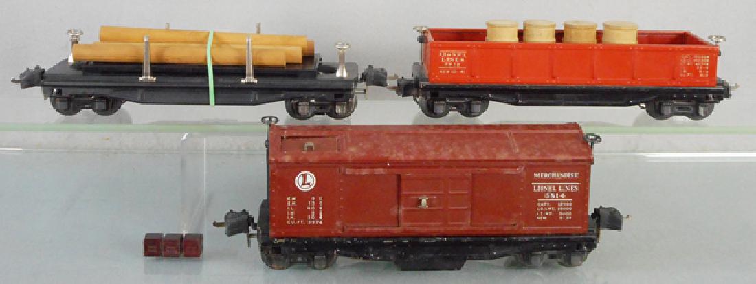 3 LIONEL FREIGHT CARS: O ga, 3811 lumber dump car, 2812 gondola w/barrels, 3814 merchandise box car, C5-7.
