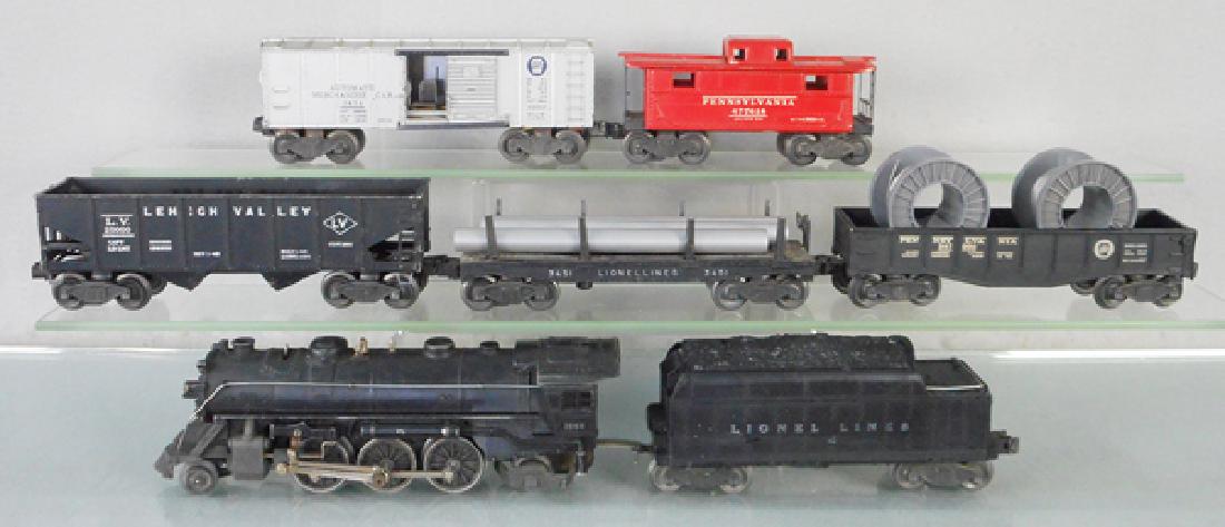 LIONEL TRAIN SET: O ga, 1666 loco, missing 1 jewel, cowcatcher has a bent step, 2466WX tender, paint & lettering worn, 6456 LV hopper, 3451 dump car w/pipes, 2452 gondola w/cable reels, 3454 automatic merchandise car,