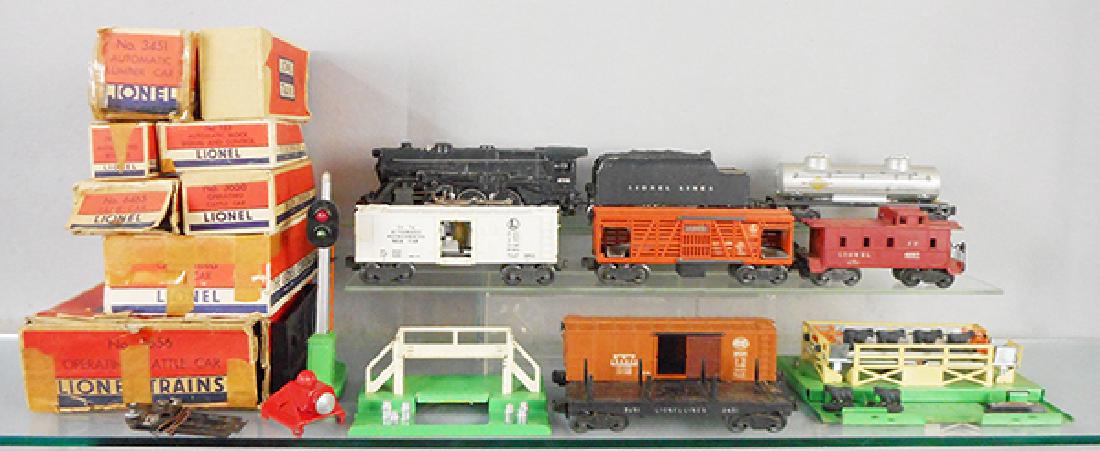 LIONEL TRAIN SET: O ga, 675 loco, missing 1 boiler front running light, 6466WX tender, 3472 milk car & platform, missing doors, 3656 cattle car & platform, 6465 tank, 3451 dump, 6454 box car, catwalk chipped, 6257 cabo