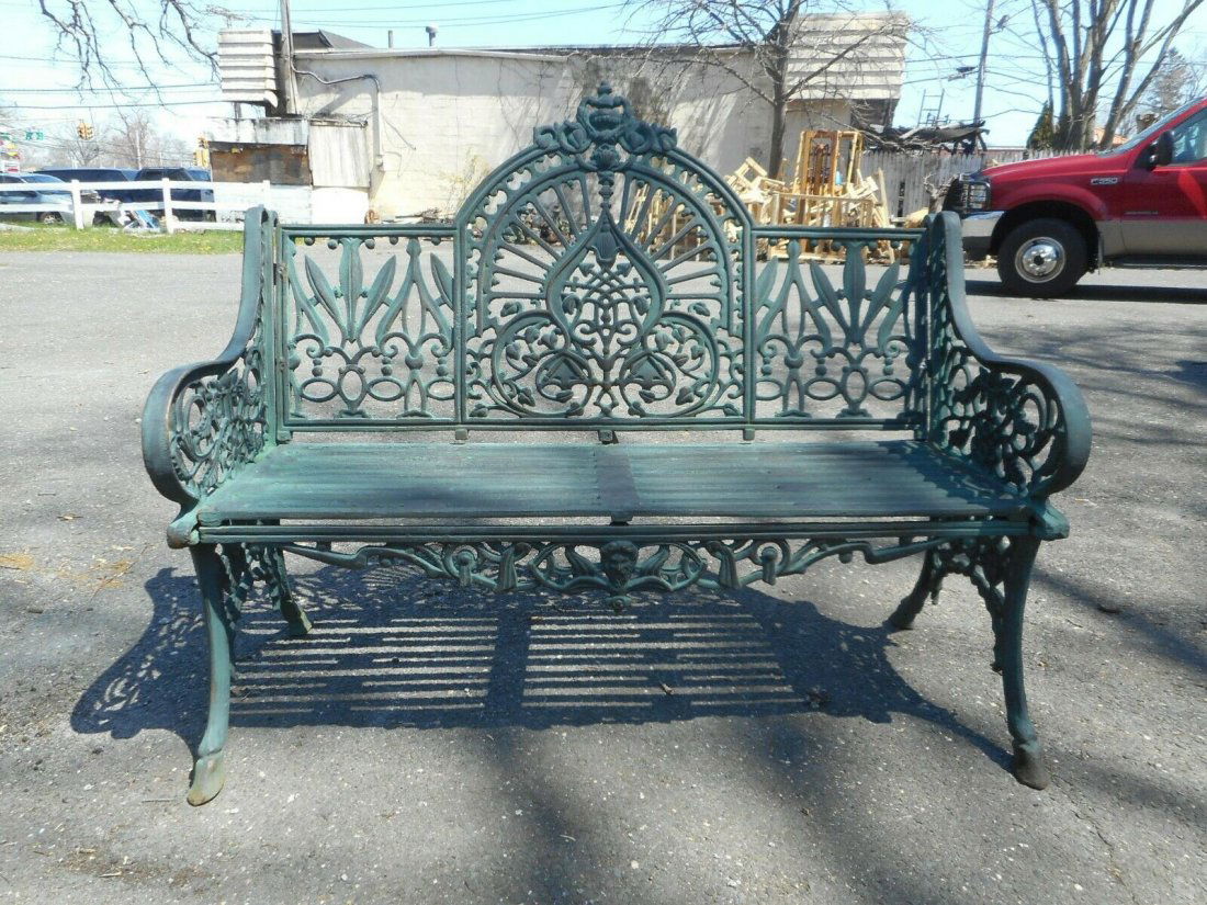Cast Iron Bench with Arched Back: This beautiful cast iron bench features sculpted arm rests, an arched backrest, and a slatted seat. A unique and comfortable design with excellent detail throughout. Splayed legs and a decorative back