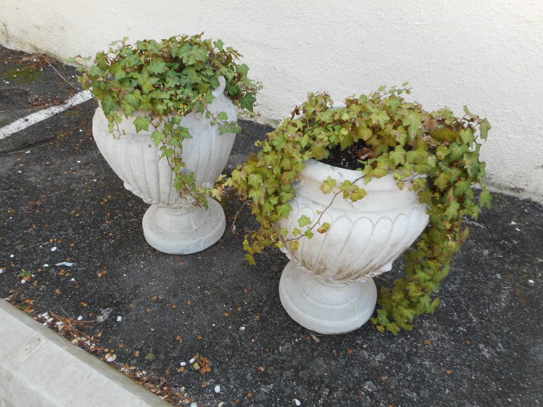 Pair of Beautiful Cement Flower Pots/Urns Circa 1979: A sculpted pair if cement urns with stunning detail etched. Stamped, "Henri Studio, Palatine 111 8330."---Condition---some edge dings, chips,--Dimensions:-- 16dia--25h--Reference number:--0183a-8895--