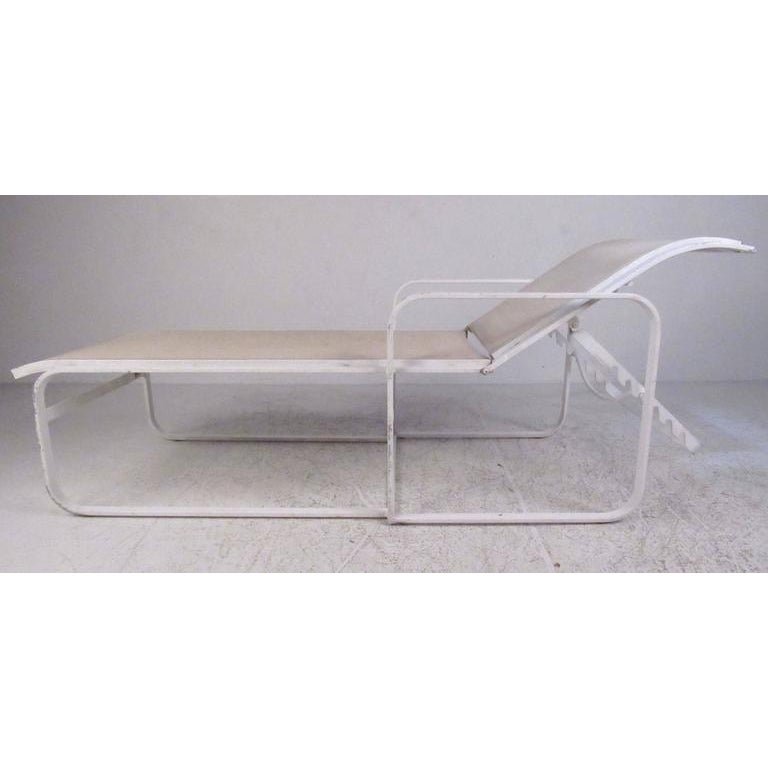 Pair of Woodard Patio Recliner Chaise Lounge Chairs: Pair of aluminum frame with nylon upholstery outdoor chaise longue chairs by the Woodard Furniture Co., circa 1980.----Dimensions: H 22 in. x W 74 in. x D 27.25 in -SH 14..5 in-----Dealer Reference: -