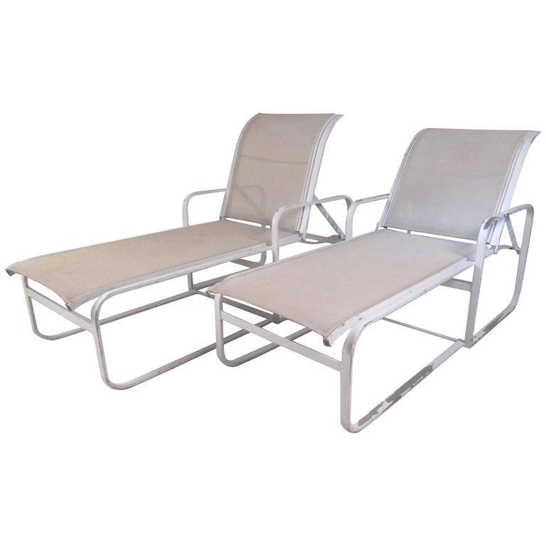 Pair of Woodard Patio Recliner Chaise Lounge Chairs: Pair of aluminum frame with nylon upholstery outdoor chaise lounge chairs by the Woodard Furniture Co., circa 1980.---Dimensions: H 22 in. x W 74 in. x D 27.25 in SH 14..5 in---LOCATION: New Jersey---