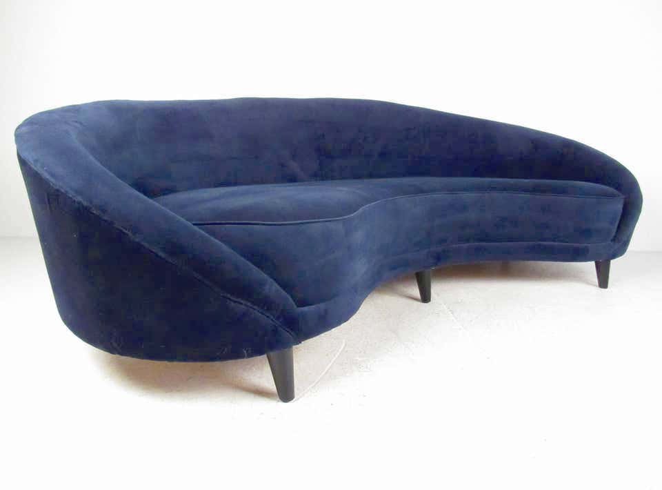 Sculptural Sofa in the Style of Federico Munari: This modern rounded back sofa features comfortable upholstered design with six tapered legs for added support. The impressive size and shape of this beautiful sculpted sofa makes it a unique addition