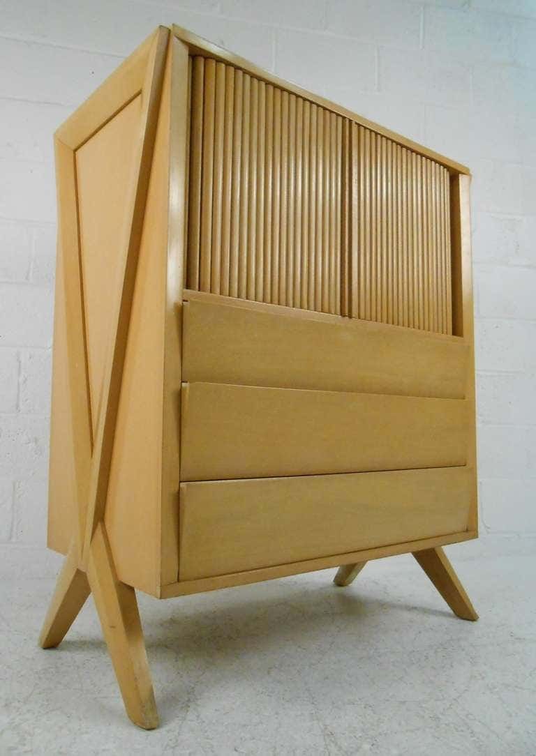 Tall Midcentury Dresser in Paul Laszlo Style: Dramatic midcentury dresser featuring bold "X-leg" design, tambour doors, and Paul Laszlo style design. This vintage sculptural dresser features six spacious drawers perfect for bedroom storage. Pleas