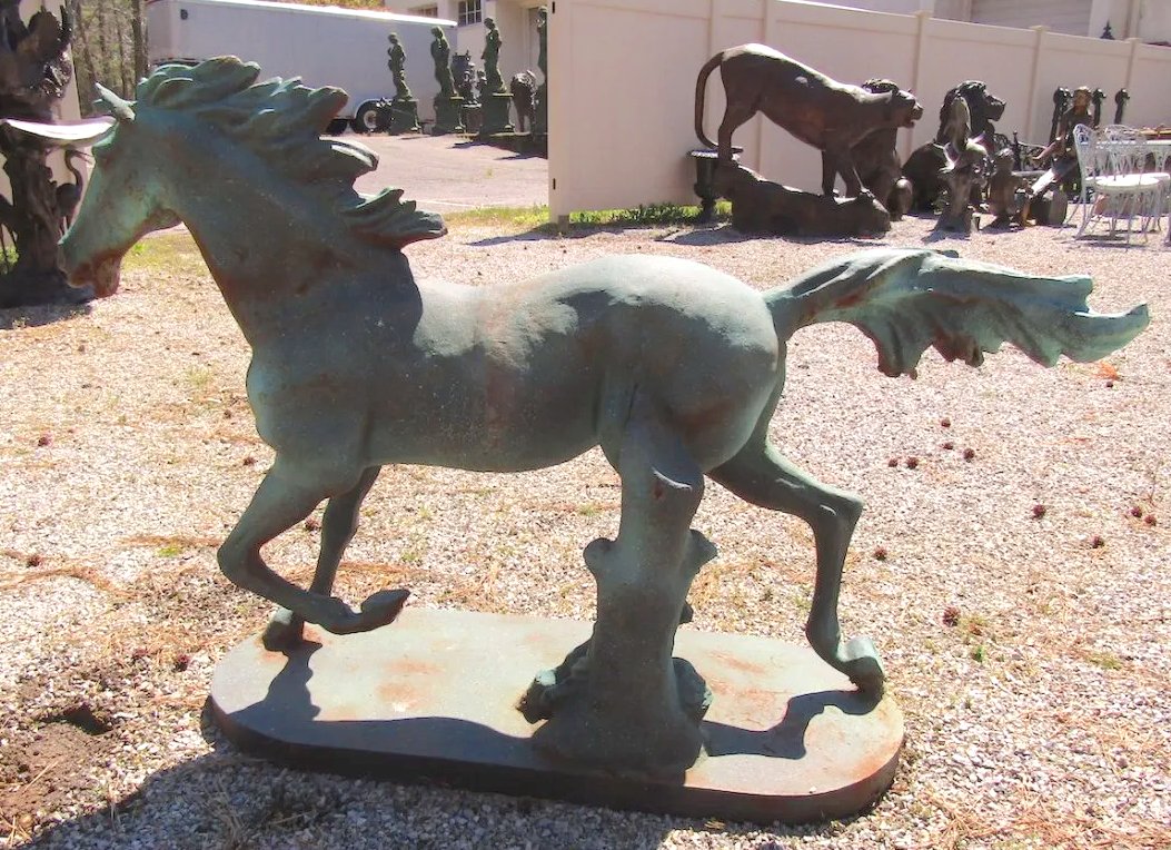 Cast Iron Horse: Running horse in iron. Beautiful formed sculpture for garden.-- PICK UP LOCATION: Brooklyn NY-- Dimensions: 16.25w, 53.25, 37h-- Condition: fading, oxidation, patina