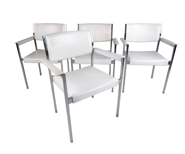 Set of Mid-Century Modern Dining Chairs by John Stuart Inc: This set of four stylish and comfortable dining chairs by John Stuart Inc feature spacious vinyl seats, upholstered armrests, and sturdy chrome frame construction. Original makers mark affixed on this