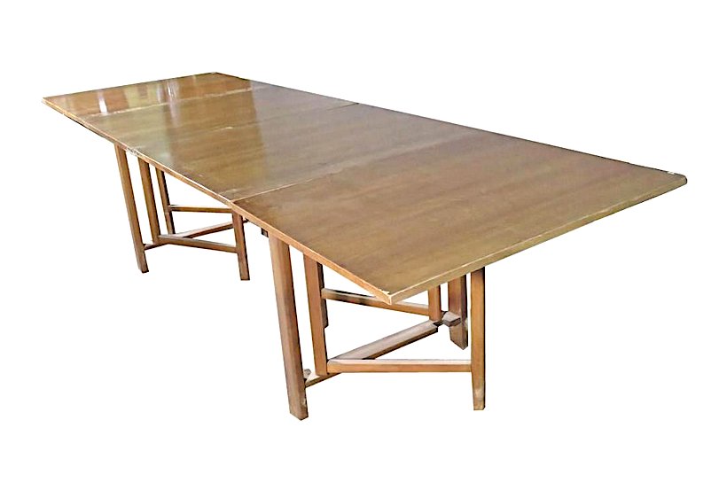 Gateleg Dining Table by Bruno Mathsson: This large walnut dining room table features a compact and portable folding design. The table's adjustable length makes it versatile for accommodating extra guests or placing in different rooms. // PI