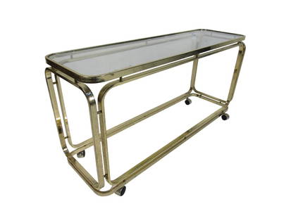 Mid-Century Modern Bar Cart: Long rolling cart in polished brass with two shelves. Used as a bar cart or rolling console table. // PICK UP LOCATION: Wall, NJ // Dimensions: Depth 16 in Width 54 in Height 26.5 in // Condition: Oxi