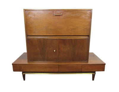 American of Martinsville "Dania" Dry Bar by Merton Gershun: This incredible dry bar cabinet by Martinsville is a Mid-Century Modern gem, with a large top compartment that lights up with holders for drinks. A lower storage compartment and slide out drawers at t