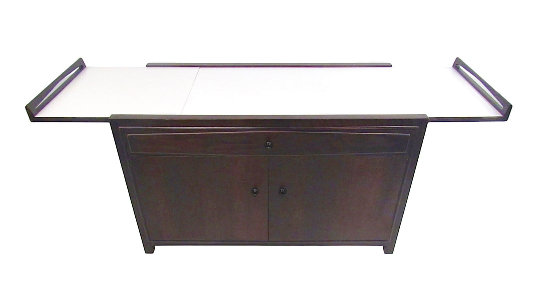 John Kapel for Glenn of California Expandable Bar Cart Cabinet: This unique Mid-Century bar cabinet features an expandable formica top with raised edges, spacious storage shelves, and a wide drawer for organizing glass ware or other items. Made by John Kapel for G