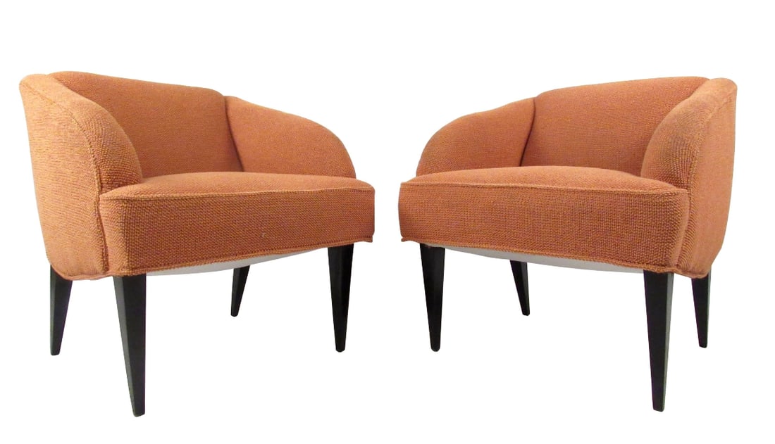 Pair Vintage Modern Club Chairs: This unique pair of mid-century modern lounge chairs features comfortable rounded seat backs, tapered black lacquer legs and uniquely modern sculpted design. Impressive pair of upholstered lounge chai