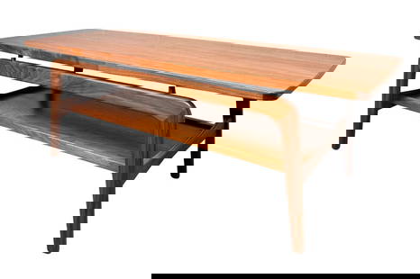 Mid-Century Modern Danish Sculpted Coffee Table: A beautifully crafted mid-century modern coffee table from Denmark, featuring rich teak wood and striking sculpted legs that add a unique, artistic touch. The clean lines and warm wood grain reflect c