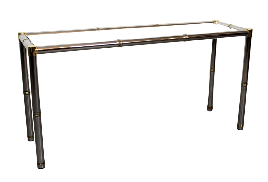 Hollywood Regency Chrome & Brass Console Table: Sleek and modern, this table features a polished chrome base paired with a clear glass top, creating a refined balance of industrial and minimalist design. The transparent surface highlights the