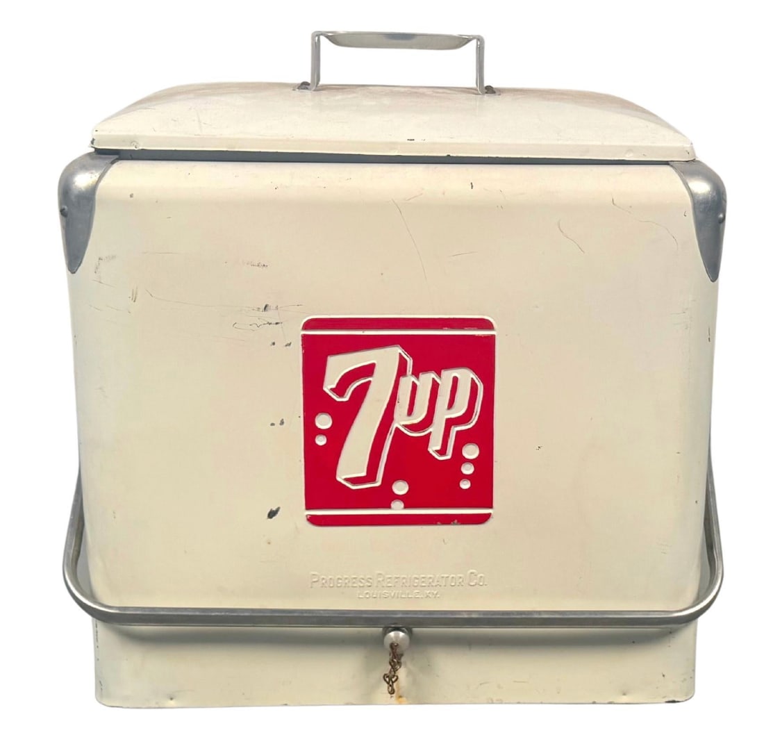 Vintage 7UP Metal Bottle Cooler From Progress Refrigerator Company: Serve a slice of Americana with this charming vintage 7UP metal bottle cooler, made by the Progress Refrigerator Company of Louisville, Kentucky—nestled somewhere between 1950–1960. This classic c