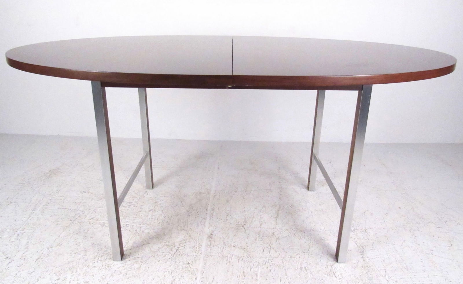 Paul McCobb Calvin Group Dining Table: Stylish aluminum trim contrasts with the rich walnut finish of this expandable dining table (additional 15-inch leaf included). // PICK UP LOCATION: WALL NJ // Condition: Wear consistent with