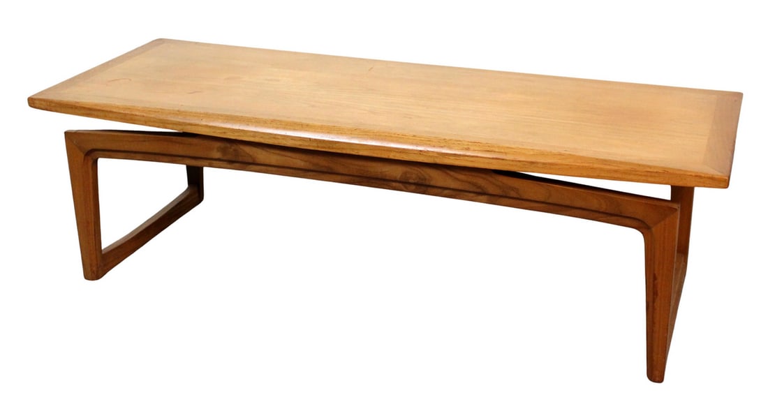 Teak Coffee Table by Remploy: A stylish mid-century coffee table by British manufacturer Remploy, crafted in beautifully grained teak. The design features clean, minimalist lines with an arching cantilever base that allows the