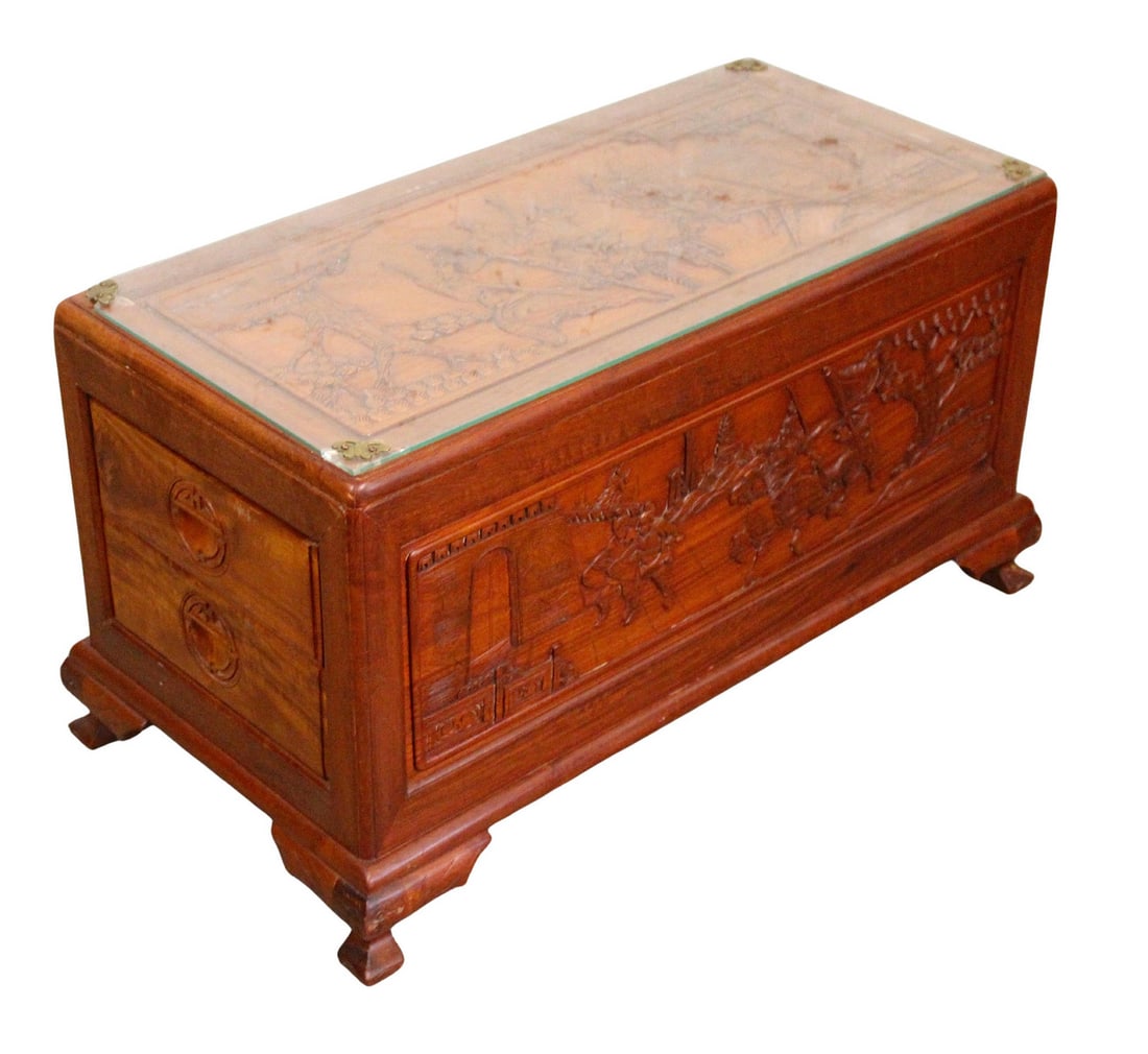 Asian Motif Coffee Table: This highly carved table is detailed on all sides, and designed as a storage trunk, but functions as a glass top coffee table. The intricate detailed engraved scenes are on the front, back and top,