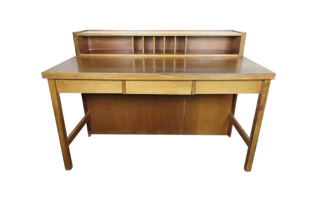 Mid-Century Modern Desk: Perfect for any home office or study, this beautiful Mid-Century Modern desk shows off a rich woodgrain and sturdy construction. A small hutch and drawer allow for organization along with a large writ