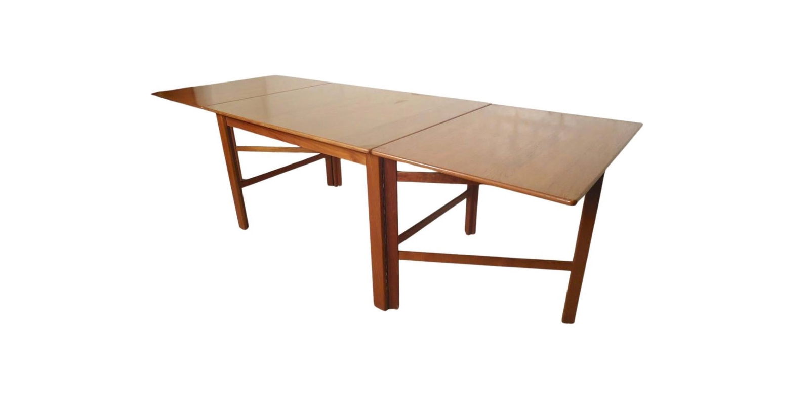 Nils Jonsson Teak Mid-Century Drop Leaf Dining Table: Danish modern dining table with two long leaves. Both leaves hang or can be taken off for a four person table, or extended to eight feet long. This gate leg table was designed by Nils Jonsson for Troe