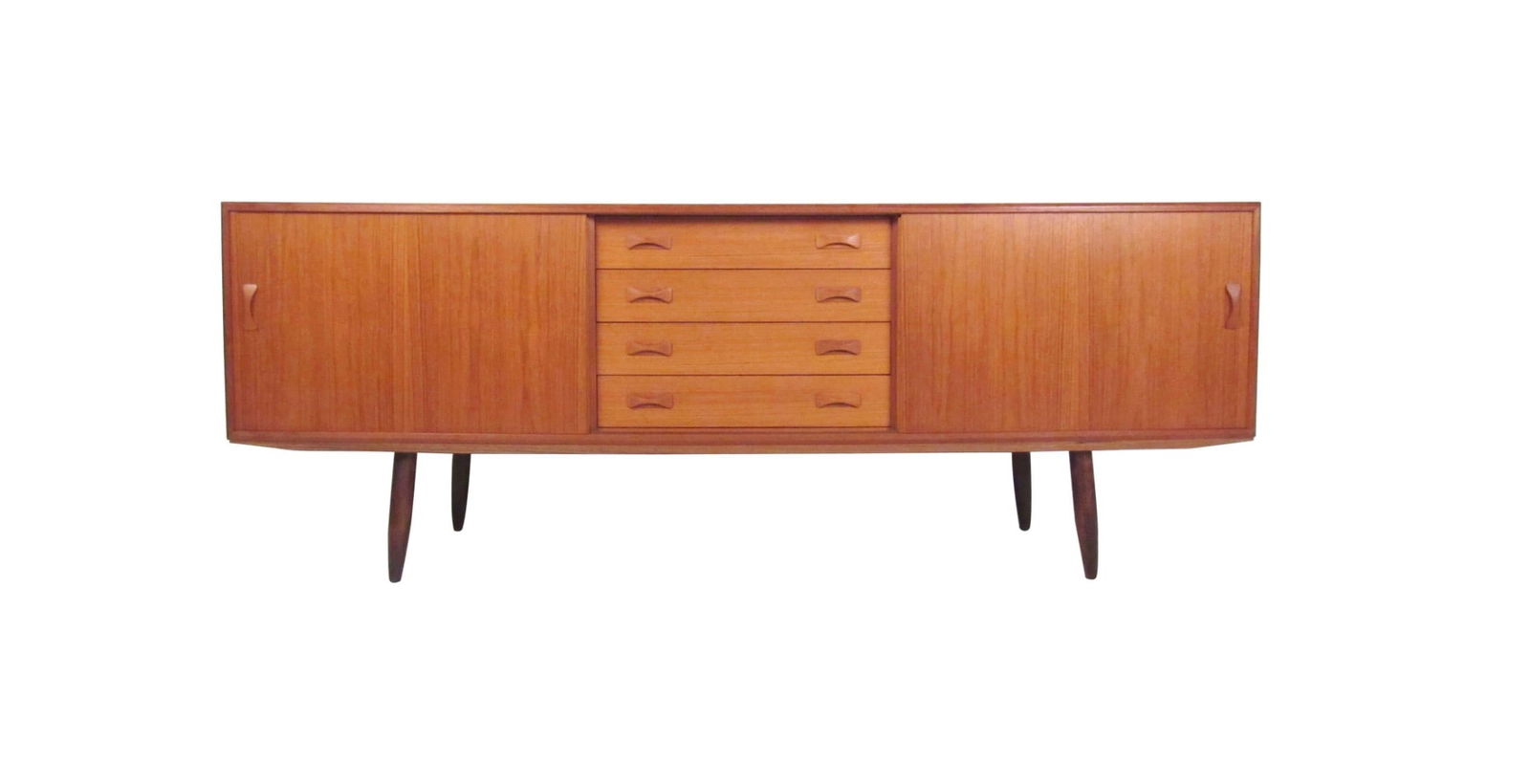 Scandinavian Modern Teak Sideboard by Clausen & Søn: This stylish teak sideboard features quality mid-century construction including dovetail drawers, carved pulls, and rich teak finish. Tapered legs and spacious storage cabinets add to the