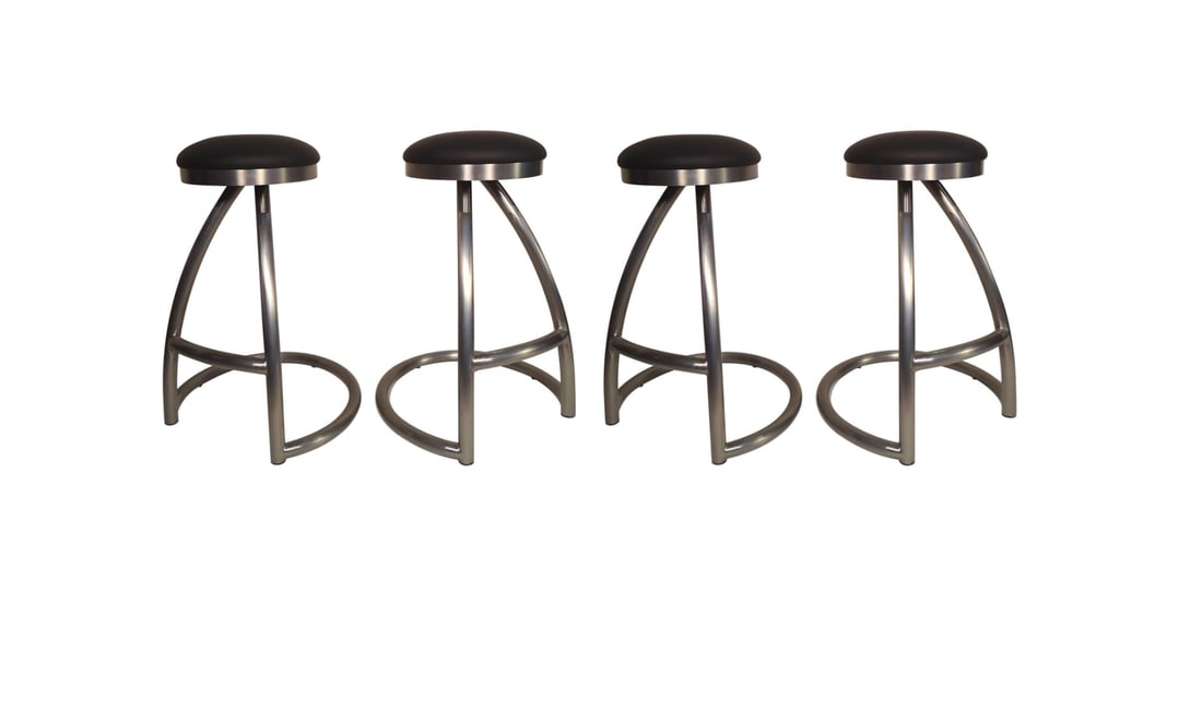 Set of Four Tubular Swivel Stools: Four heavy stools with black cushioned seats. Thick metal frames with footrests. // Pickup Location: Brooklyn, NY // Condition: Good. Wear consistent with age and use. Minor fading. Some