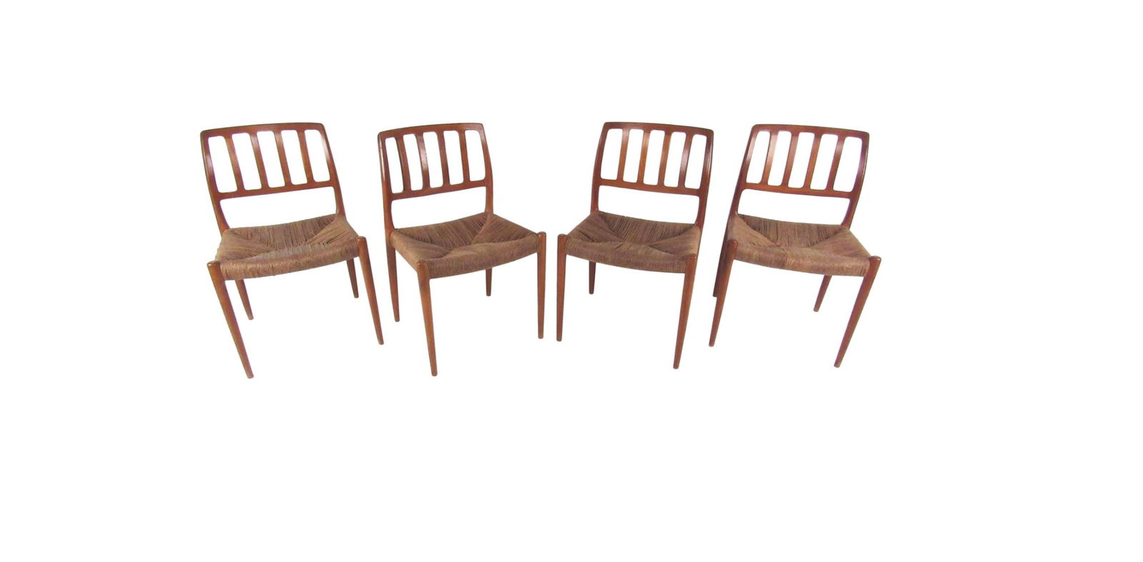 N.O. Møller Teak and Rush Seat Dining Chairs: This gorgeous set of four dining chairs designed by N.O. Møller features woven rush seats and unique sculpted backs. These beautiful chairs make an impressive statement in any setting. // Pickup Loca