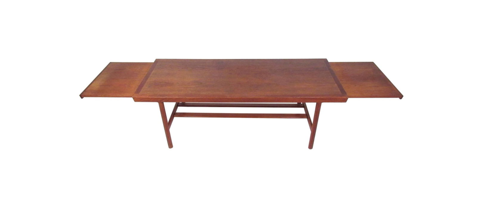 Mid-Century Danish Teak Extendable Coffee Table: Well constructed Danish modern table with two 16.75" hidden extension leaves which can be opened independently or together for a maximum width of 96". A Sleek design with two stretchers running vertic