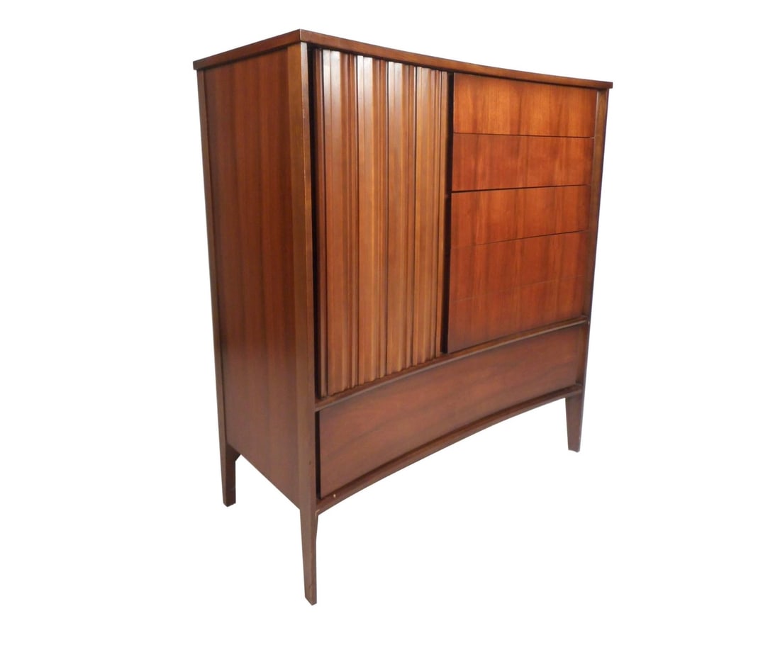 Mid-Century Modern Walnut Curved Front Highboy Dresser: This beautiful vintage modern dresser features a unique curved front with a large hidden drawer on the bottom. There is plenty of room for storage within its nine hefty drawers with four of them