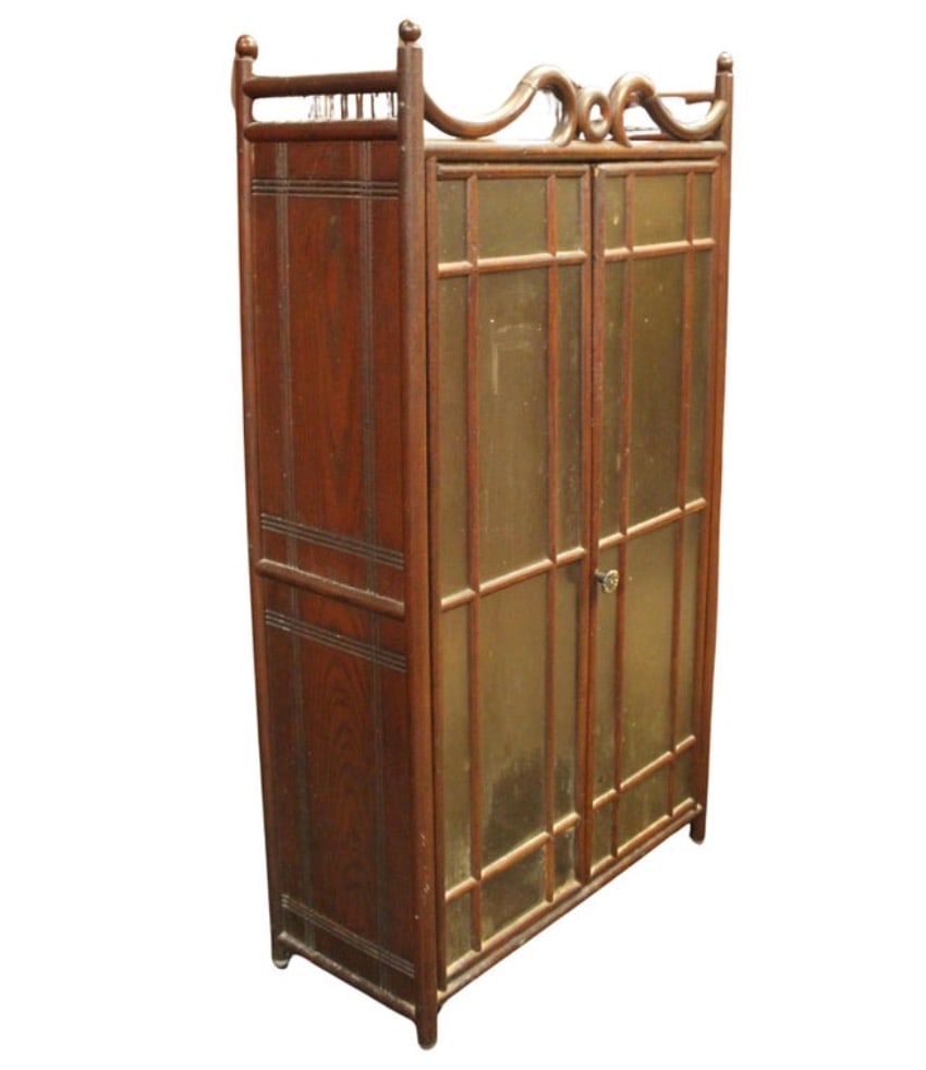 Early 20th Century Faux Bamboo Display Cabinet: Early 20th Century mini cabinet made of oak wood with scrolled bentwood ornamentation. Two toned glass doors give privacy to your storage. Light weight construction gives you a wall mount option. 