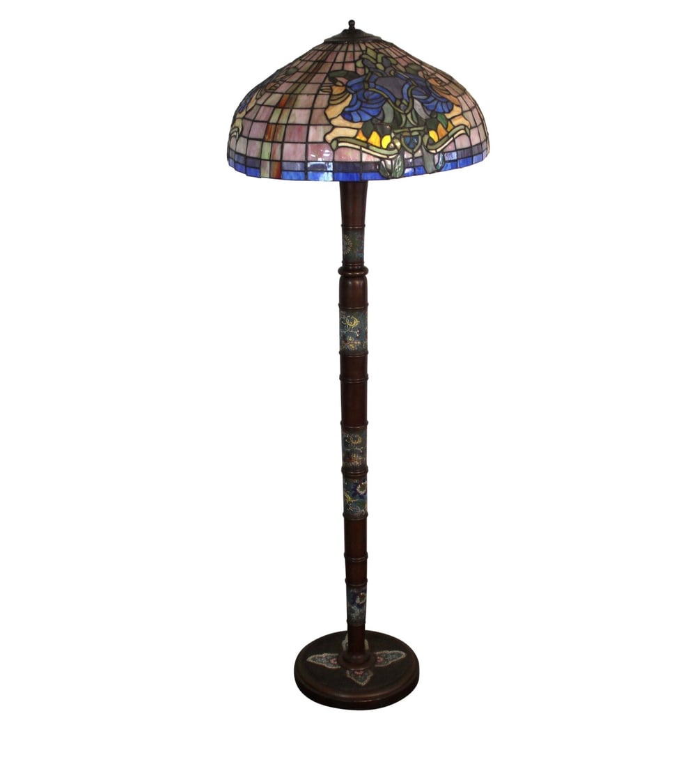 Antique Bronze Floor Lamp with Stained Glass Shade: Antique Tiffany-style floor lamp featuring a richly colored stained glass shade with intricate floral motifs. The ornate metal base complements the handcrafted glasswork, casting a warm, ambient glow.