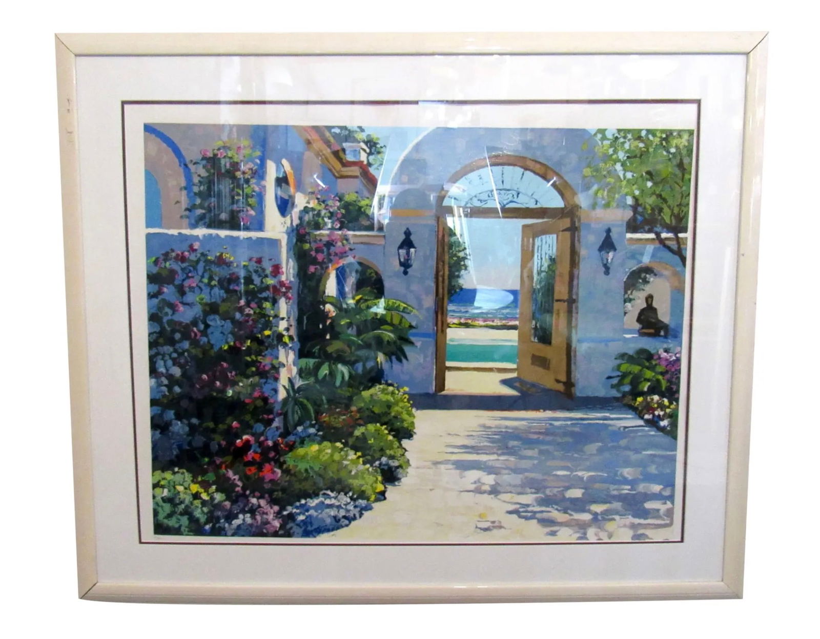 Framed Garden Print: This impressive framed print displays a lush garden scene in brilliant colors. The artwork is held in a white frame and glass cover. // PICKUP LOCATION: Brooklyn, NY // Condition: Good. Minor