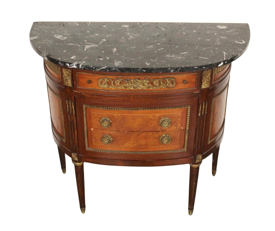 French Louis XVI Style Demilune Commode Chest: Petite Louis XVI style commode with amazing detail. Half round body with two center drawers, tapered legs, brass hardware, inlay mahogany and burl veneers, and thick marble top. // PICKUP