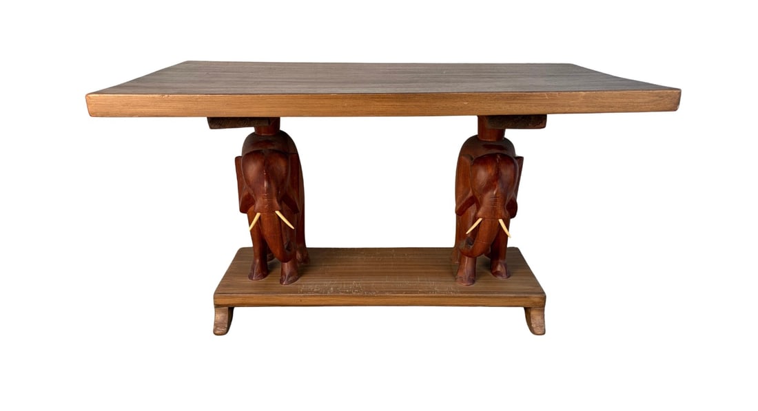 Unique Hand Carved African Elephant Console Table: A unique small console table featuring two beautifully carved wooden elephant heads serving as the front legs. Rich in decorative detail and cultural character, this sculptural piece blends