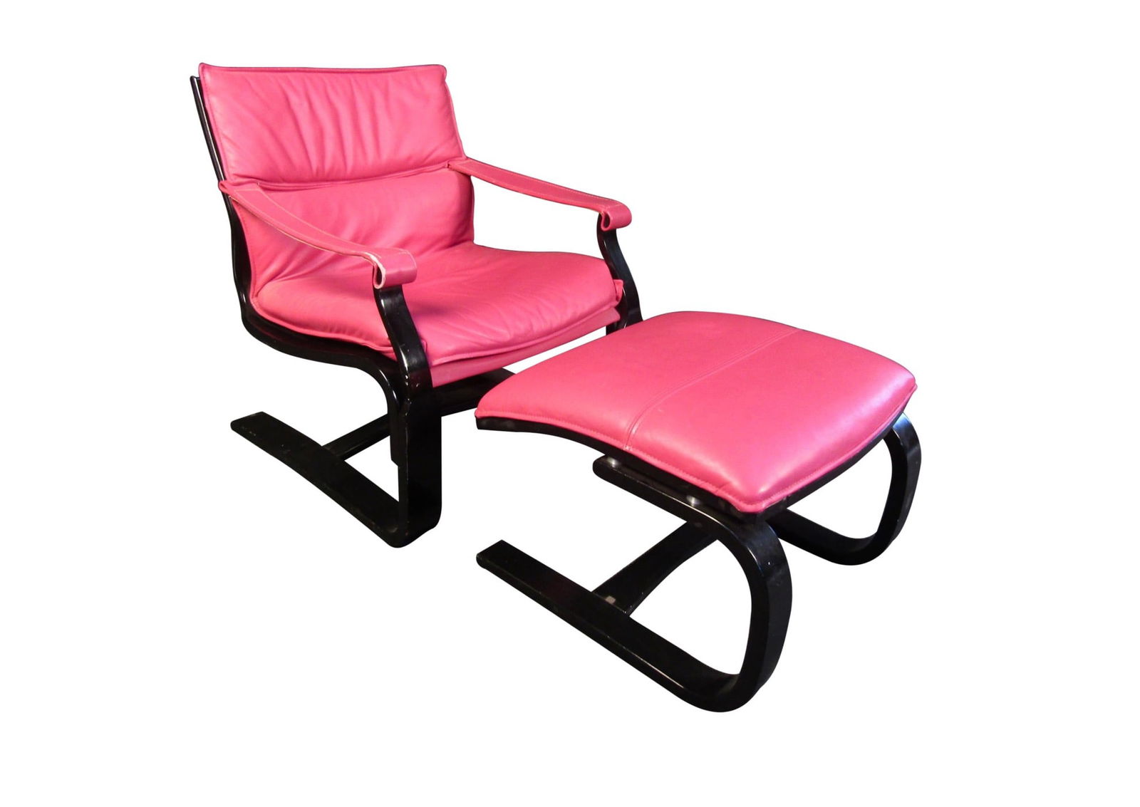 Vintage Leather Lounge Chair and Ottoman Set: This vintage lounge chair and ottoman set is full of bold Mid-Century Modern style. Vibrant pink leather contrasts with a black wooden frame making this set as eye-catching as it is comfortable. // PI