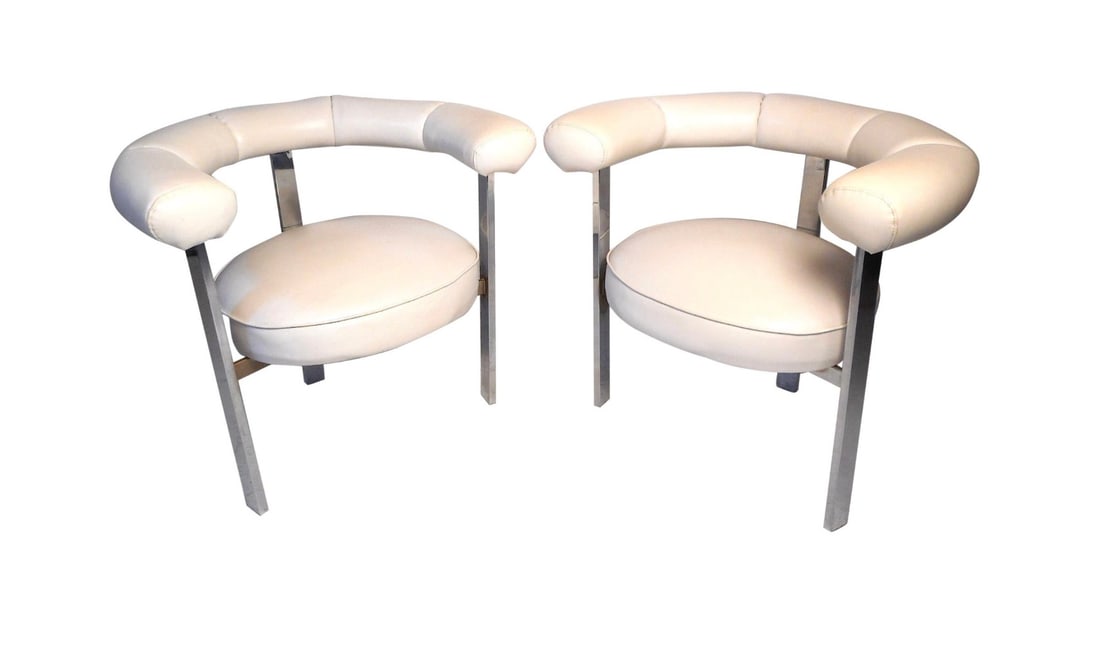 Pair of Midcentury Faux-Leather and Chrome Barrel-Back Chairs: This impressive set of Mid-Century Modern barrel chairs feature a lovely white faux-leather upholstery supported by a sturdy chrome frame. These unique chairs are a perfect addition to any home,