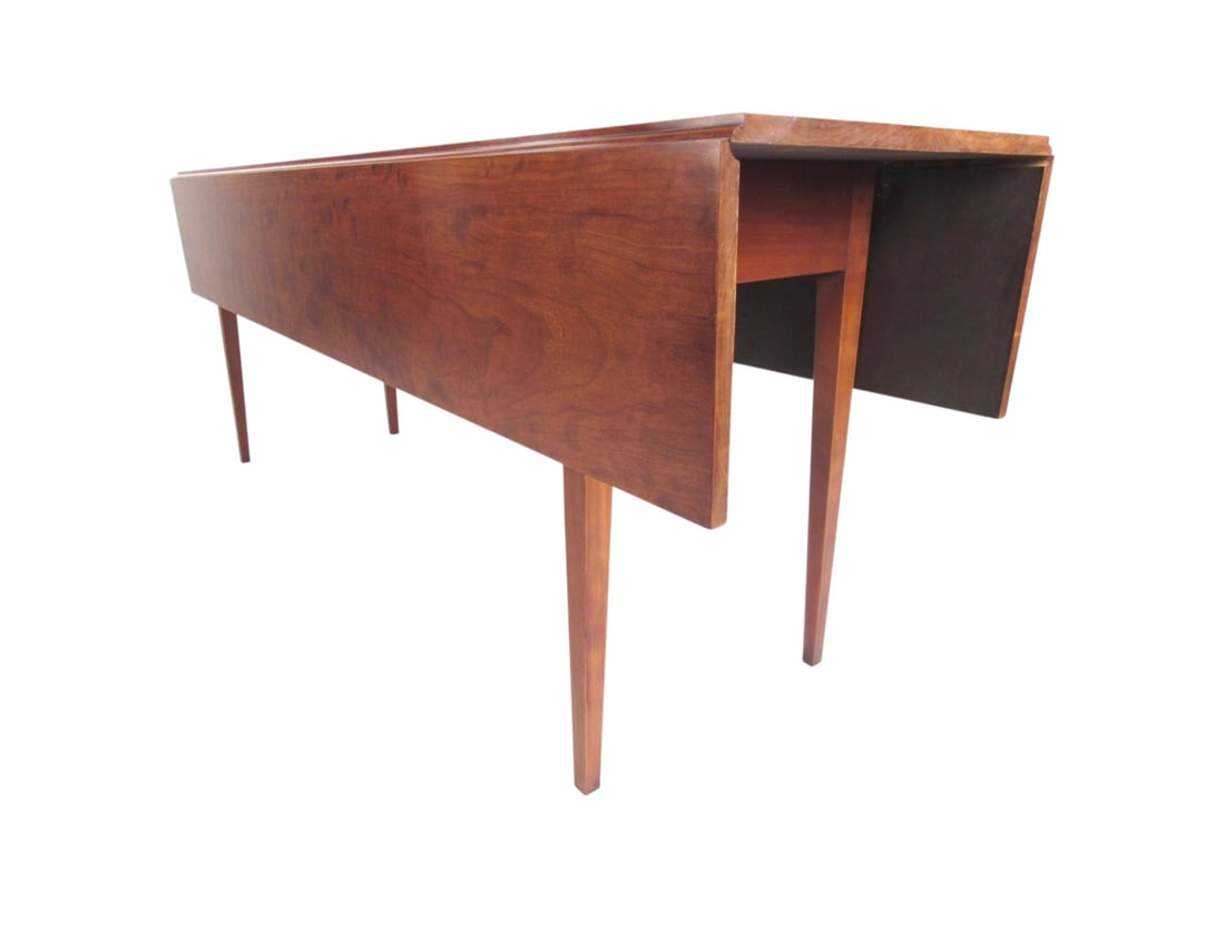 Vintage Eldred Wheeler Cherry Drop Leaf Dining Table, Mid-Century: This exquisitely long vintage dining table features a rich cherry wood finish, and quality drop leaf construction. Elegant tapered legs compliment the stunning wood grain, while the versatility to