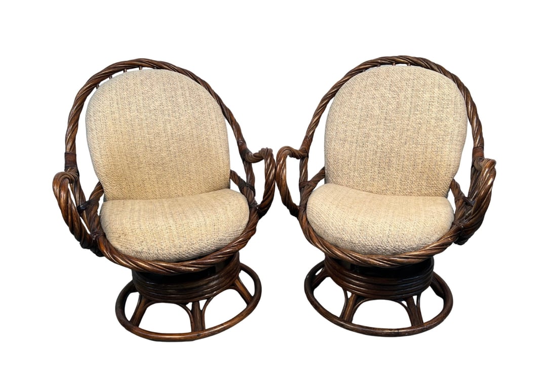 Pair of Reed and Bamboo-Wrapped Swivel Chairs: This stylish pair of 1970s swivel chairs features a distinctive reed and bamboo-wrapped frame, combining natural texture with mid-century modern flair. Their gently curved seats and swivel bases