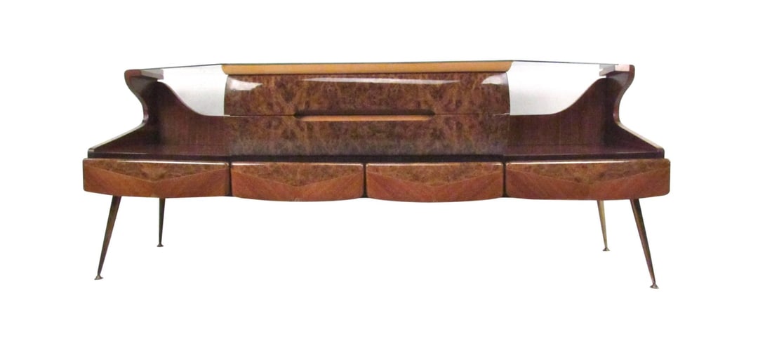 Italian Glass Top Sideboard in the Style of Vittorio Dassi: This stunning vintage sideboard features a lacquered burl wood finish, tapered brass legs, textured glass top and a unique shape. // PICKUP LOCATION: WALL, NJ // Condition: Good. Wear