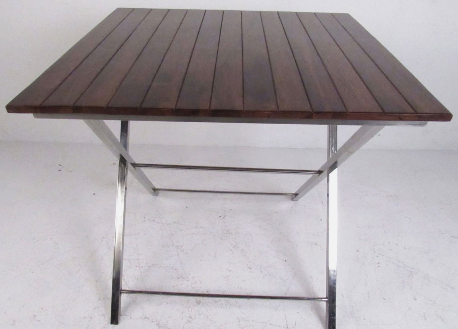 Contemporary Modern Wood and Metal Collapsible Kitchen Table (8450)NJ: Versatile mid-century modern style table features the ability to collapse for convenient storage. Beautiful slatted top with remarkable wood grain and a sturdy metal "X" base. This stylish piece is