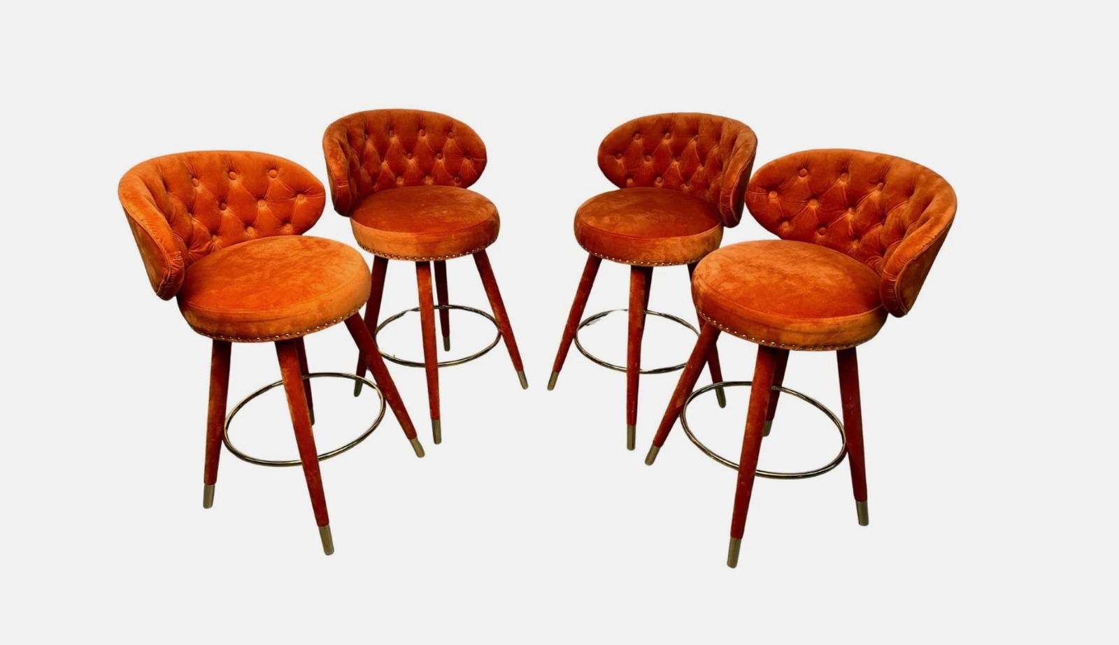 Set of Four (4) Orange and Brass Swivel Barstools: Striking set of four mid-century style barstools featuring vibrant orange upholstery and sleek brass bases. The swivel design combines comfort with eye-catching appeal, making them perfect for a