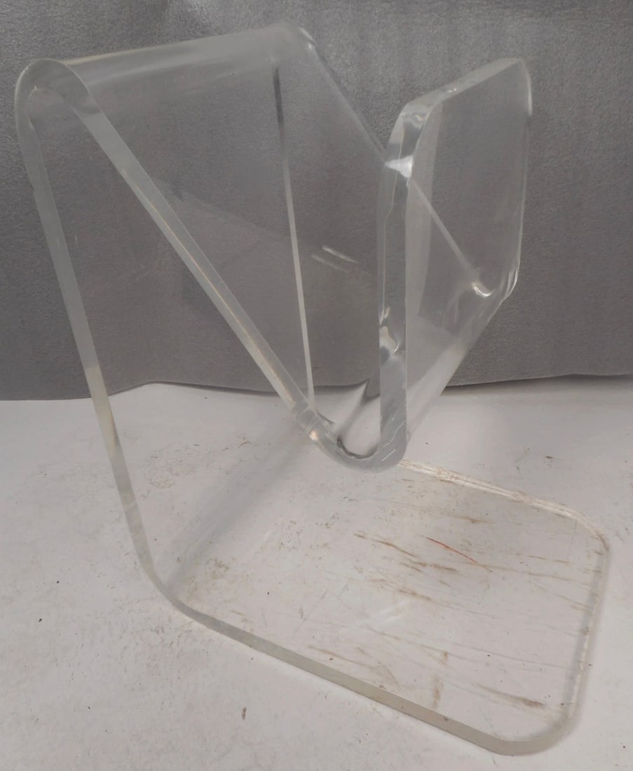 Unusual Mid-Century Modern Lucite Magazine Rack: This beautiful vintage modern magazine holder is made entirely of thick lucite. This stylish and versatile piece offers convenient placement of items with a height of 25.5 inches. Extremely unique