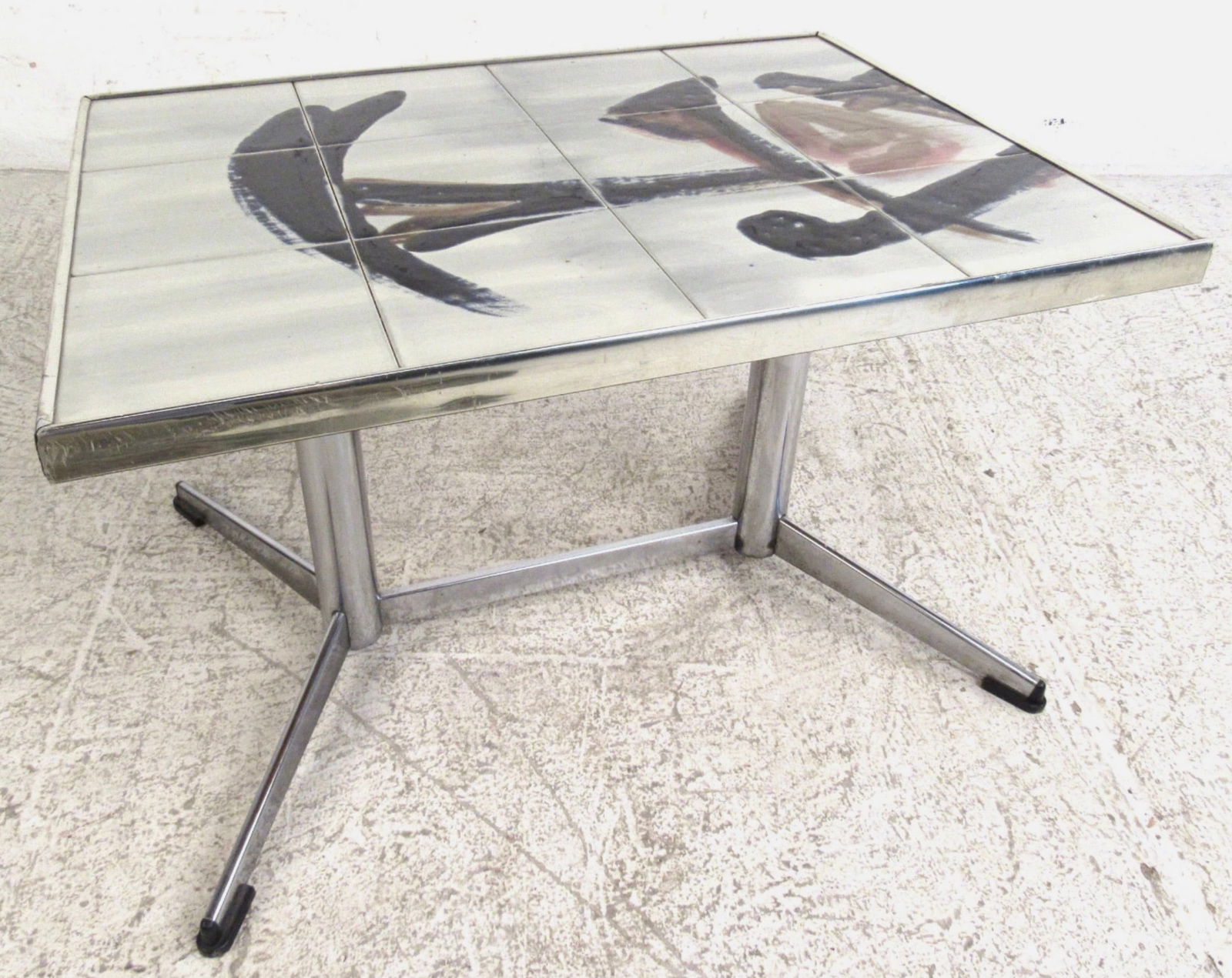 Mid-Century Modern Tile Top End Table with Chrome Base: This beautiful mid-century modern end table features a tile top with symbols and a chrome base. The design provides sturdiness and style in any setting. Perfect addition to home, business, or office.