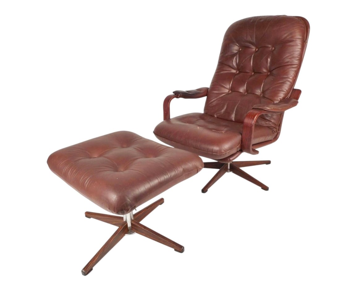 Mid-Century Tufted "Kropp Stolen Original" Lounge Chair and Ottoman: This gorgeous Mid-Century burgundy vinyl lounge chair and ottoman features tufted cushions, rosewood armrests and a swivel base. The comfortable and iconic design is labeled "Imported by Finmark Inc,