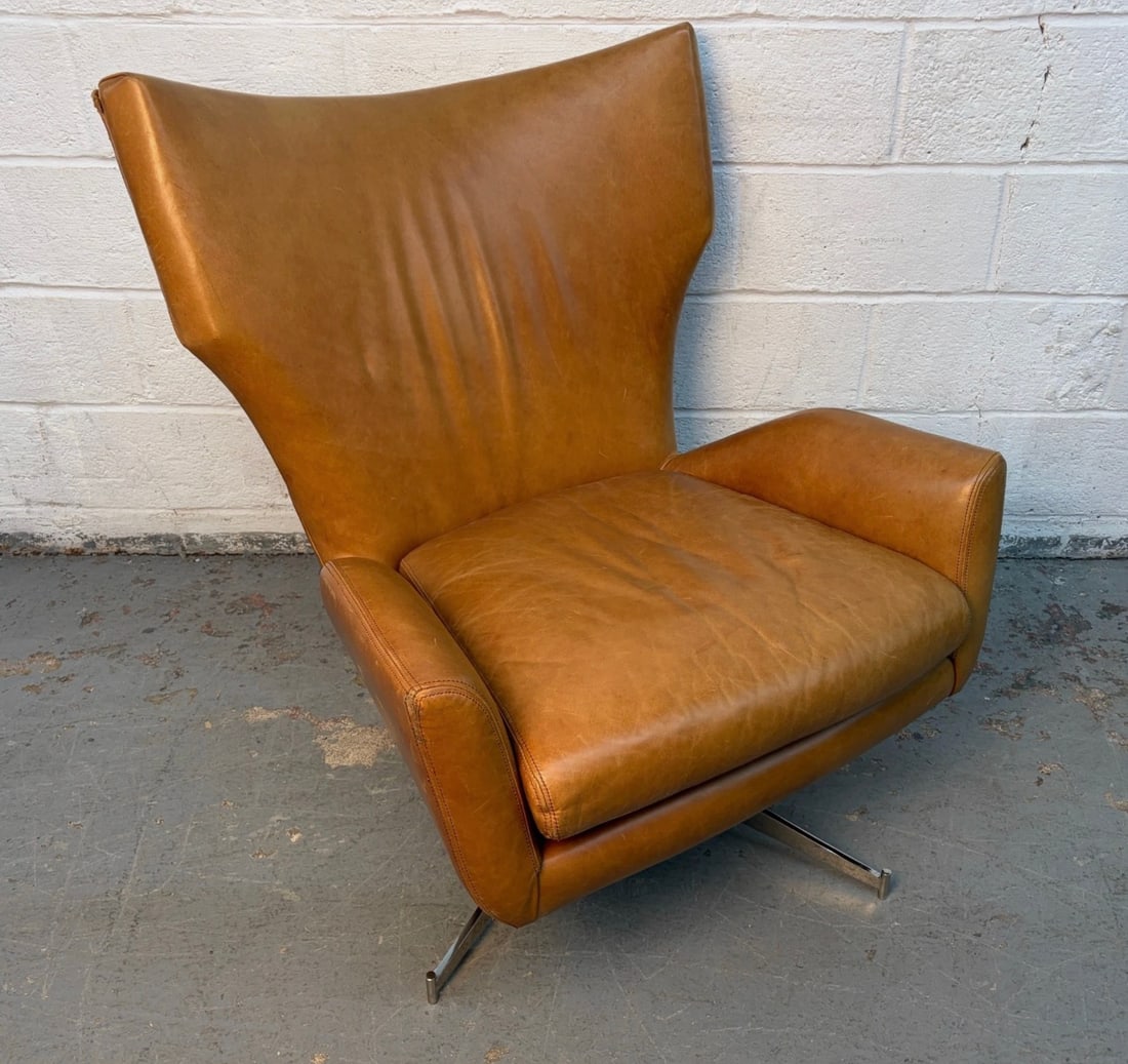 West Elm Hemming Wingback Swivel Lounge Chair: Add a touch of modern classic style and exceptional comfort to your living space with the West Elm Hemming Wingback Swivel Lounge Chair. Upholstered in premium leather and inspired by vintage
