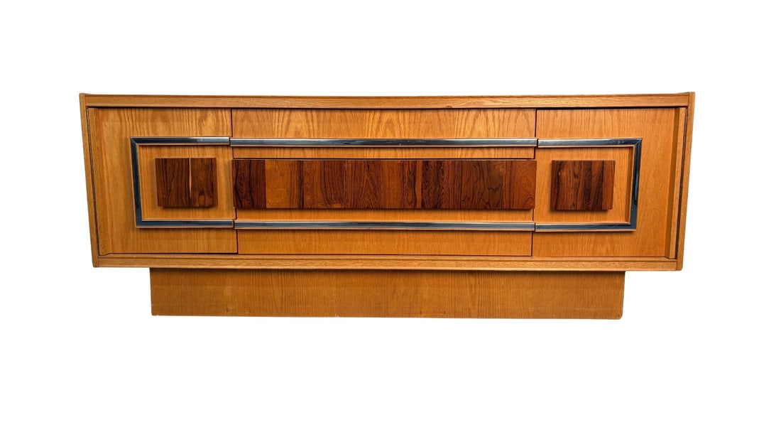 Milo Baughman Style Brutalist Mid Century Oak and Chrome Lowboy Dresser: Striking and architectural, this Milo Baughman–style lowboy dresser embodies the bold confidence of mid-century Brutalist design. Crafted in warm oak with strong, linear grain, the piece is