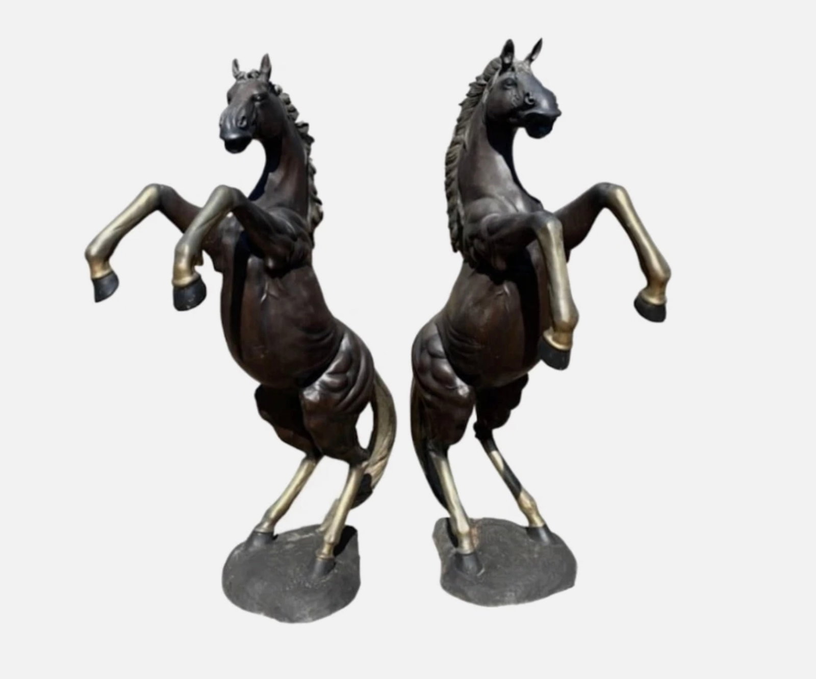 Pair of Bronze Horse Statues: These impressive bronze statues stands at 85 inches tall and has a beautiful patinated finish. The realistic physique, gold brushed mane, and silver legs add to the allure. This elegant lifesize