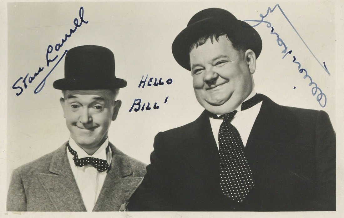 Vintage black and white half length photograph of Stan: Vintage black and white half length photograph of Stan Laurel and Oliver Hardy in a characteristic pose while wearing their bowler hats, signed by both actors and inscribed "Hello Bill!" in Laurel's h